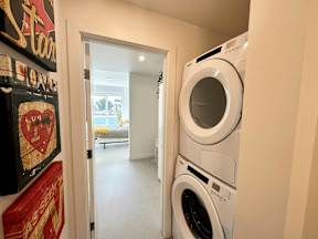 A white washing machine is in a small room.