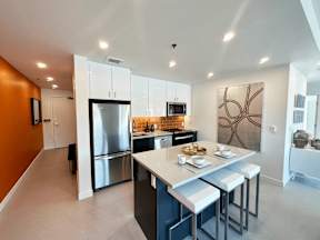 A modern kitchen with a large island and stainless steel appliances.