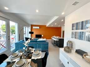A modern dining room with a table set for a meal.