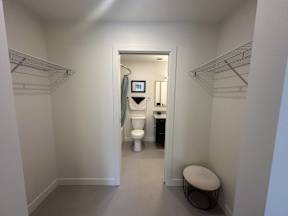 A small bathroom with a toilet, sink, and a mirror.