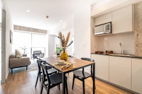 a kitchen and dining area with a table and chairs