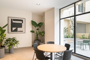 a dining room with a table and chairs and a large window