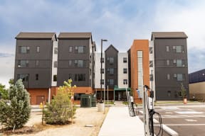 a row of apartment buildings with bicycles parked in front of them