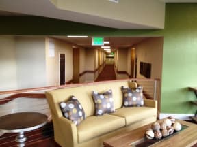 a long hallway with a couch and a table