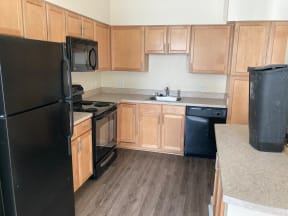 a kitchen with black appliances and wooden cabinets