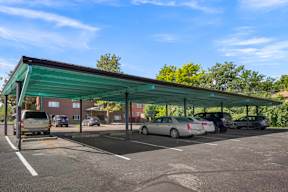 a parking lot with cars parked under awning