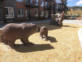 three bears statues in front of a building