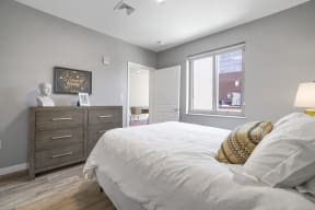 a bedroom with a bed and dresser in a 555 waverly unit