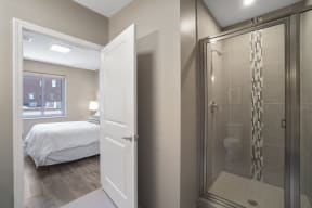 a bedroom with a bed and a shower in a room