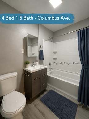 Bathroom with dark wood vanity and white subway tile at OSM Properties Homes & Apartments, Chico, CA