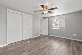 Empty bedroom with ceiling fan and closet at OSM Properties Homes & Apartments, Chico, California