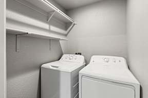 Laundry room with washer dryer and storage shelving at OSM Properties Homes & Apartments, Chico