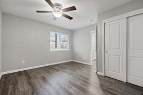 Empty bedroom with ceiling fan and window at OSM Properties Homes & Apartments, California