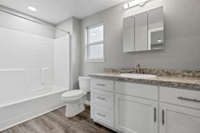 Bathroom with white vanity and granite countertop at OSM Properties Homes & Apartments, California, 95926