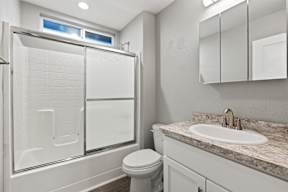 Bathroom with glass shower door and granite vanity at OSM Properties Homes & Apartments, Chico, 95926