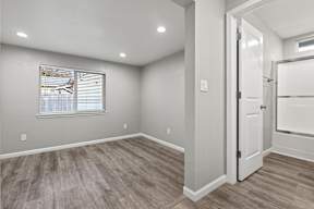 Empty bedroom with ensuite bathroom access at OSM Properties Homes & Apartments, Chico, California
