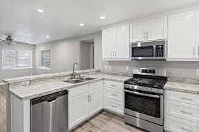 Modern kitchen with white cabinets and granite counters at OSM Properties Homes & Apartments, Chico