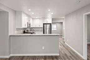 Open concept kitchen with breakfast bar and modern finishes at OSM Properties Homes & Apartments, California, 95926