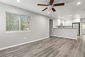 Open living area with kitchen passthrough and ceiling fan at OSM Properties Homes & Apartments, Chico, CA 95926