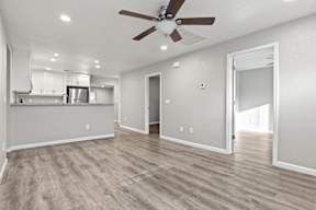 Open living and dining space with ceiling fan at OSM Properties Homes & Apartments, Chico, CA