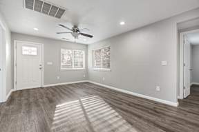 Bright living room with large windows and ceiling fan at OSM Properties Homes & Apartments, Chico, California