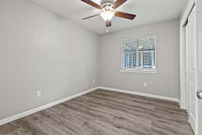 Empty bedroom with ceiling fan and white blinds at OSM Properties Homes & Apartments, Chico