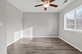 Vacant bedroom with vaulted ceiling and wood fan at OSM Properties Homes & Apartments, California