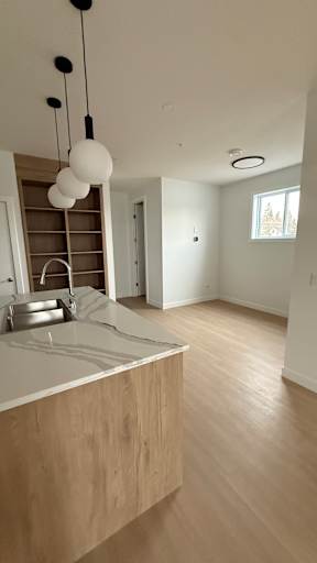 A kitchen with a wooden counter and a sink.