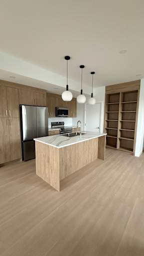 A modern kitchen with wooden cabinets and a central island.
