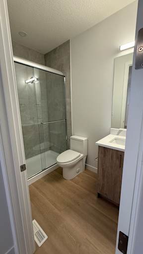 A bathroom with a toilet, sink, and shower.
