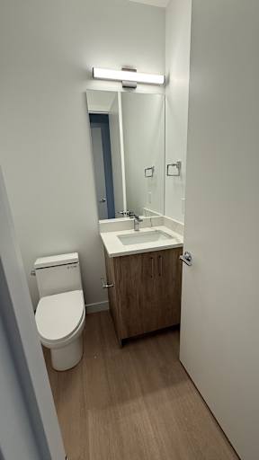 A white toilet sits next to a sink in a small bathroom.