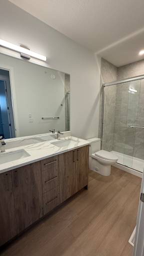 A bathroom with a white sink and a toilet.