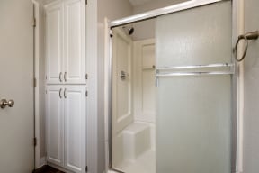 a bathroom with a shower and closet in a 555 waverly unit