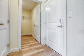 a hallway with two doors and a closet in a 555 waverly unit