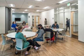 a group of people sitting at tables in a room