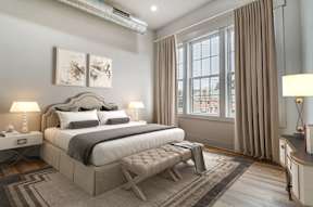 a bedroom with a bed and a window