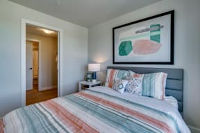 a bedroom with a bed and a nightstand with a lamp