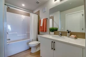a bathroom with a toilet sink and shower