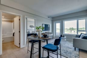 a kitchen and living room with a large window and a view of the city of Calgary