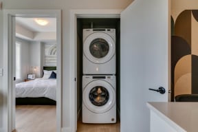 a front load washer and dryer in a bedroom