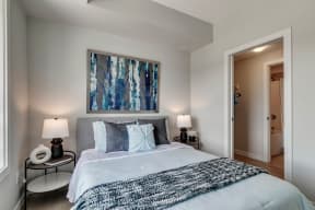 a bedroom with a large bed and two night stands with lamps