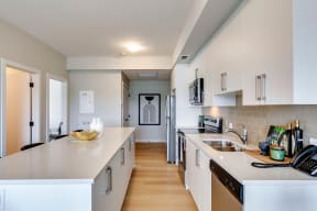 a kitchen with white cabinets and a large island