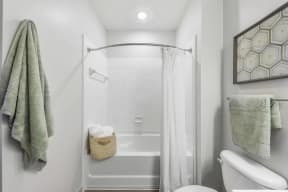 a bathroom with a white bathtub and a white shower curtain