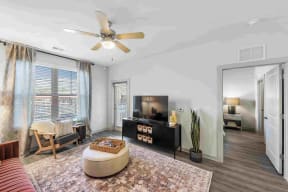 a living room with a large window and a ceiling fan south twenty cartersville ga
