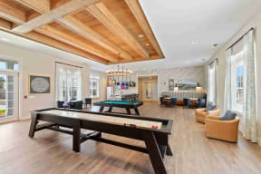 the gathering place at gardner village resident lounge with pool table and ping pong table
