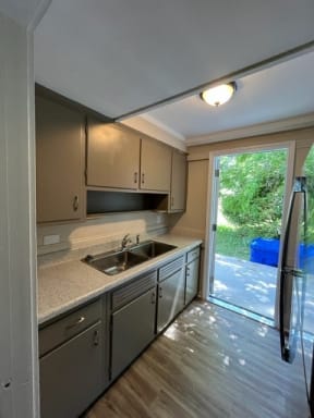 a kitchen with a sink and a refrigerator