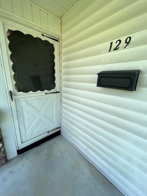 a white door on the side of a house
