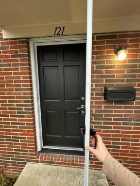 a person is unlocking a door with a key