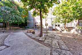 A park with a paved walkway and benches.