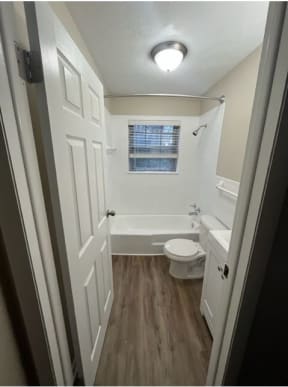 a small bathroom with a toilet and a tub